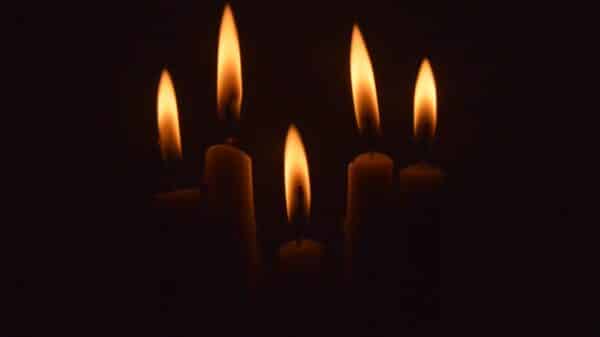 a group of lit candles in the dark