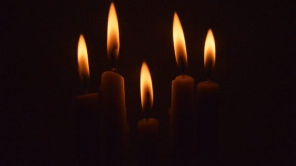 a group of lit candles in the dark