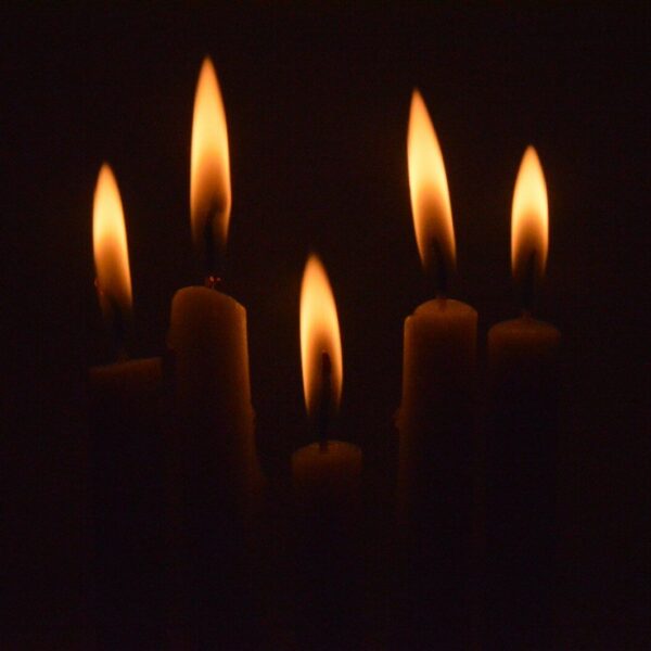 a group of lit candles in the dark