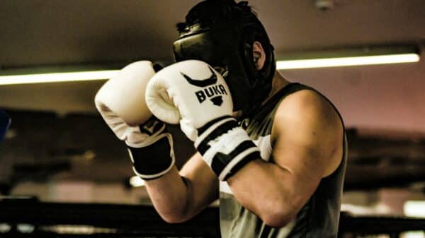 a man wearing a white and black boxing glove